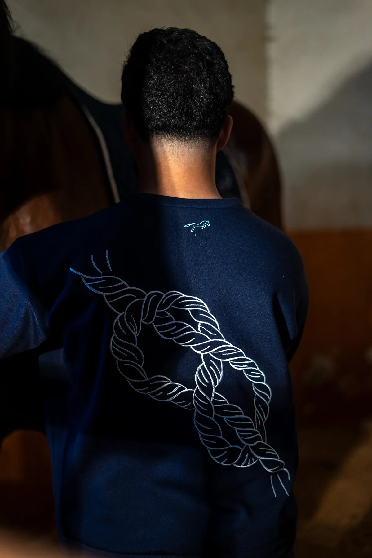 Gros plan sur la broderie cheval du sweat